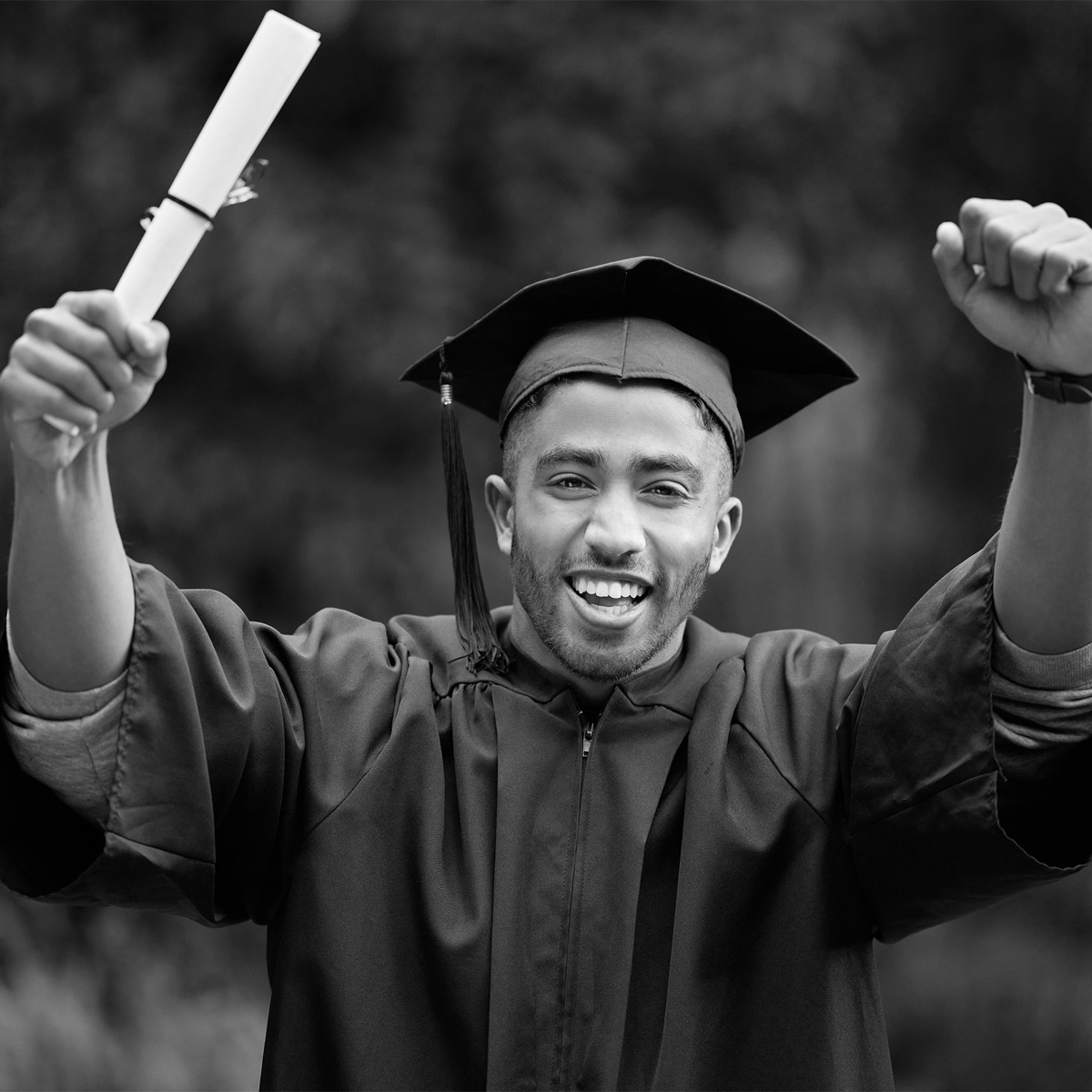 Graduate celebrating with diploma in hand