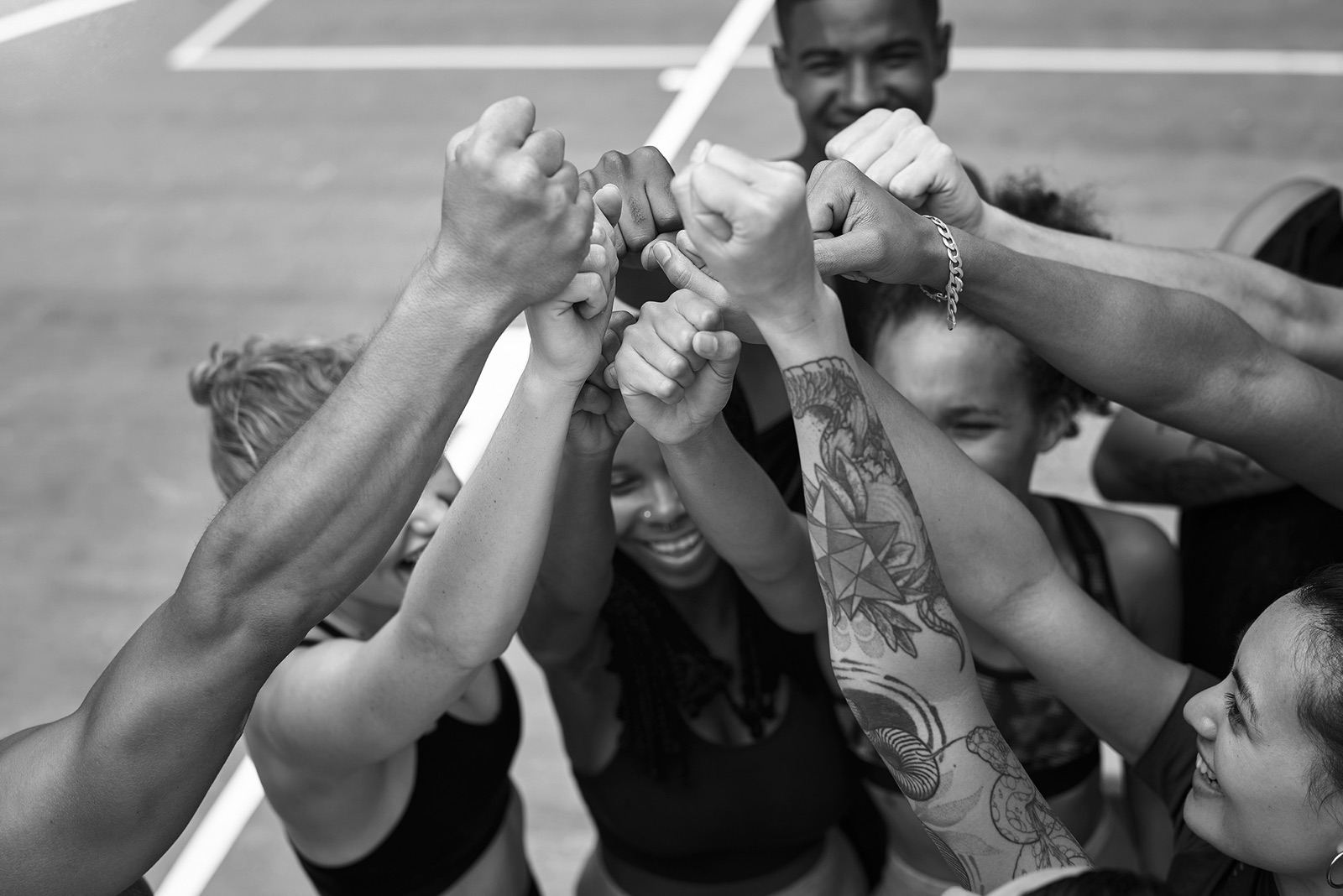 College students with fists raised together in a huddle